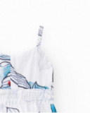 Abito per bambina in bianco con spalline e stampa floreale.
