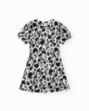 Abito per bambina in bianco e nero con maniche a sbuffo e stampa floreale.