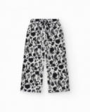 Pantaloni per bambina in bianco con vita elastica e stampa floreale.