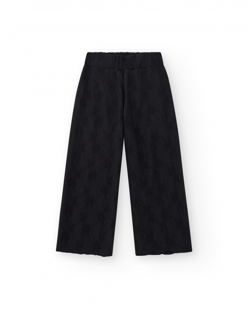 Pantaloni per bambina in nero con vita elastica e ricamo.