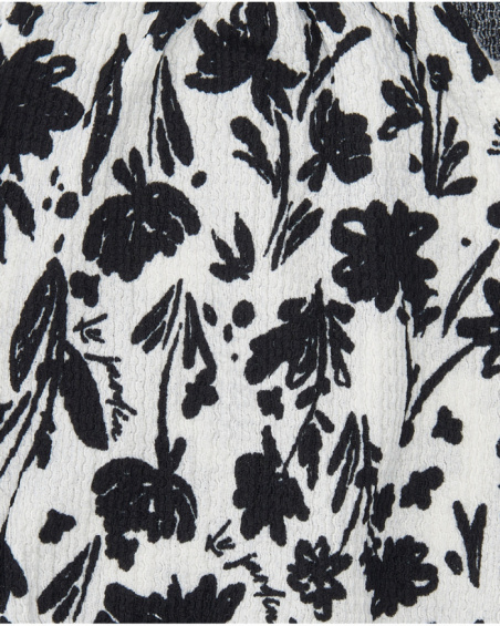 Top per bambina in bianco con spalline e stampa floreale.