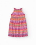 Vestito per bambina con stampa multicolore e spalline regolabili.