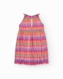 Vestito per bambina con stampa multicolore e spalline regolabili.