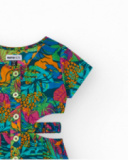 Tuta per bambina con stampa tropicale, bottoni frontali e aperture laterali.