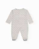 Tutina in maglia grigio chiaro per bambina con stampa a pois neri.