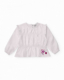 Blusa a maniche lunghe per bambina bianca con dettaglio di volant.
