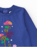 Maglietta a maniche lunghe per bambina colore blu con stampa floreale multicolore.