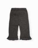 Pantaloni in maglia per bambina in grigio con volant sull’orlo.